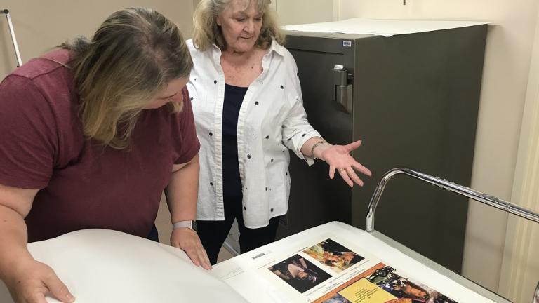 Val Lehmann looks at a poster with NFSA staff person, Belinda Hunt