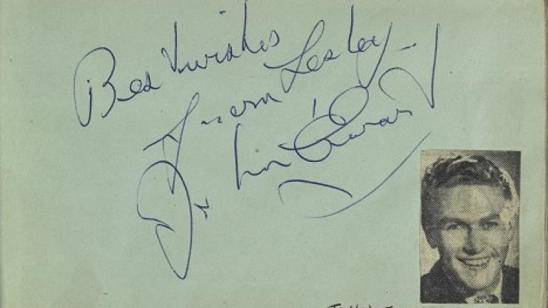 John Ewart's autograph with picture cut from a magazine in Lesley Cansdell's autograph book
