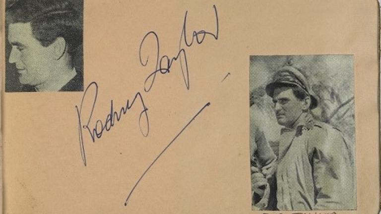 Rod Taylor's autograph with two pictures cut from a magazine in Lesley Cansdell's autograph book