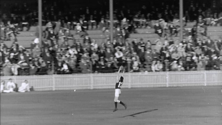 Jack Collins marks the ball in a AFL match