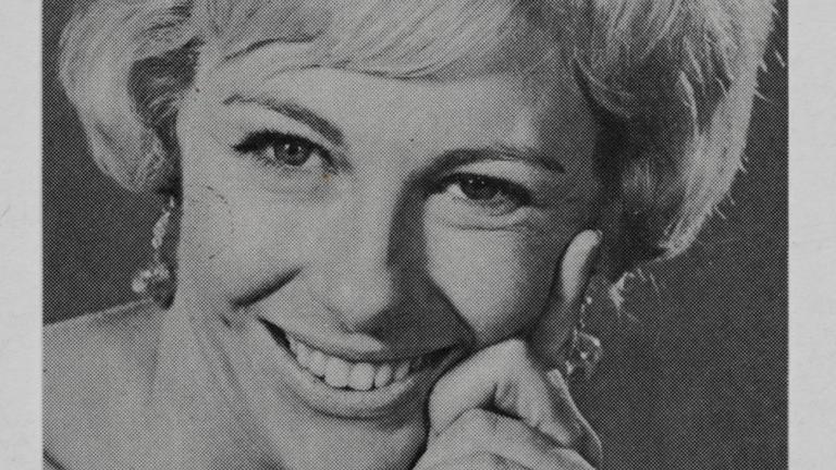 Close up of young woman with short blonde hair smiling