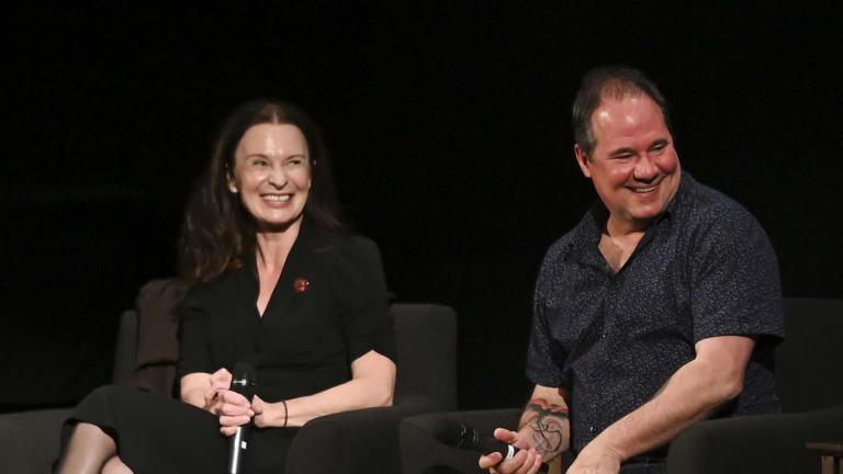 Tara Morice and Paul Mercurio laughing while seated on stage at the NFSA during a Q&A session about Strictly Ballroom