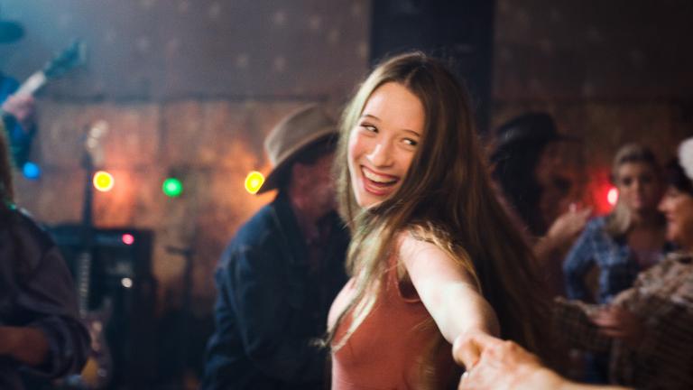 Sophie Lowe laughing and looking at the camera in a scene from the film Beautiful Kate