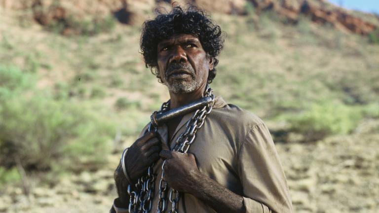 David Gulpilil as The Tracker, with a chain around his neck, in a scene from the 2002 film The Tracker