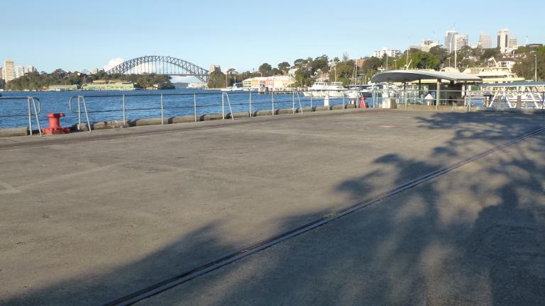 View of warf on Sydney Harbour with an old rail line in the foreground