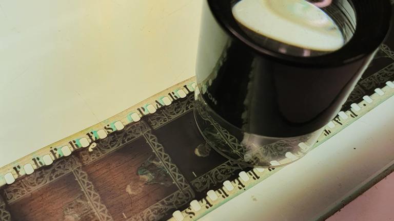 Strip of film with a magnifying glass on top of it