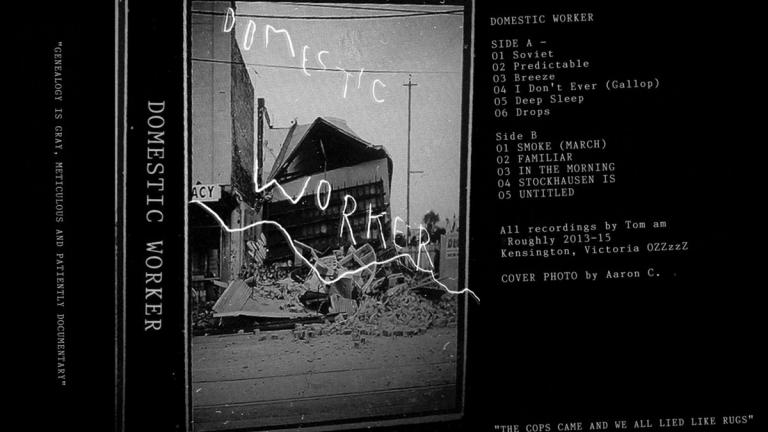 Cassette cover featuring a partly destroyed building. Text reads: Domestic Worker.