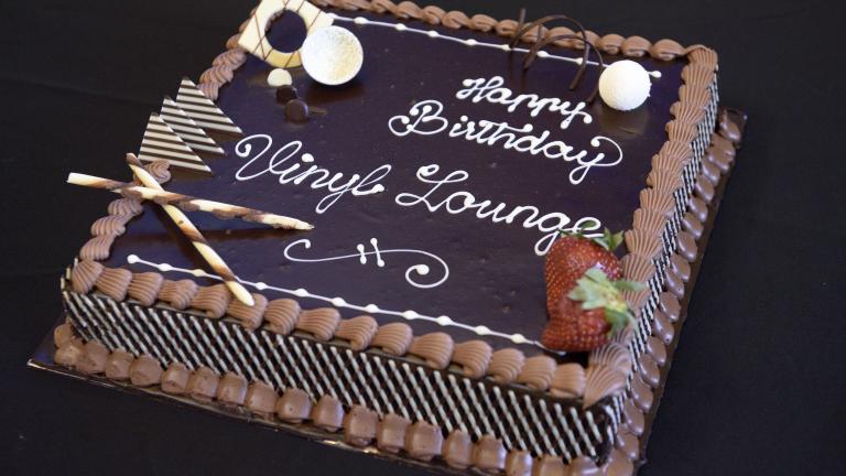 Chocolate cake with icing that says 'Happy birthday Vinyl Lounge'