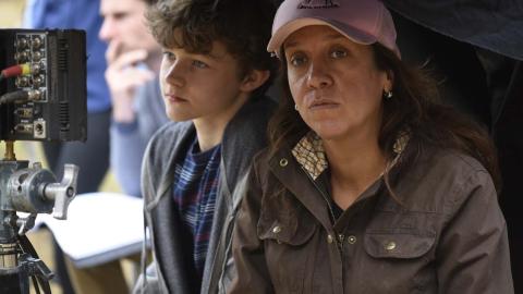 Director Rachel Perkins on a film set with child actor Levi Miller. Levi is looking through a monitor while Rachel looks at the camera