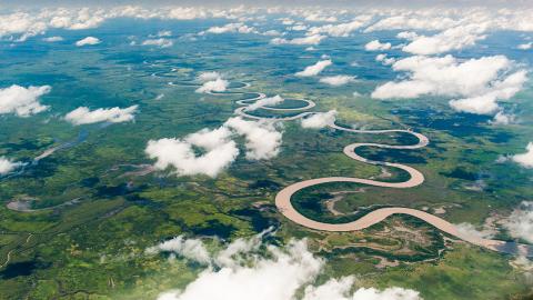 A waterway snaking through Arnhem Land as seen through a layer of cloud from the air