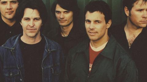 Head and shoulders shot of the five members of the band Powderfinger standing side by side looking at camera.