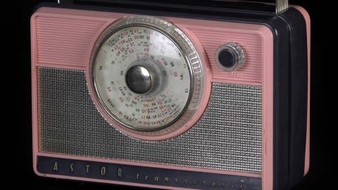 A pink and grey Astor 7 transistor radio from the 1950s or 1960s