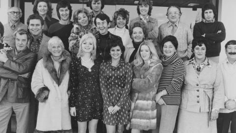 A group photograph of about 30 men and women, c1970s