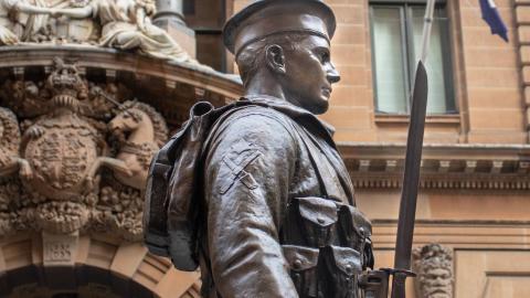 Detail of a statue of a soldier in uniform, part of an Anzac memorial