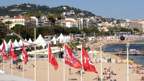 The beach front at Cannes with red flags in the foreground