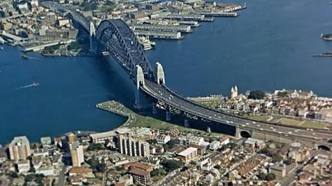 Aerial view of Sydney Harbour Bridge with Kirribilli and Milsons Point in the foreground and the Walsh Bay and Rocks area at the top of the image