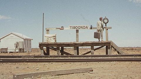 John Grant waits alone on an outback railway station platform in a still from the 1971 film Wake in Fright
