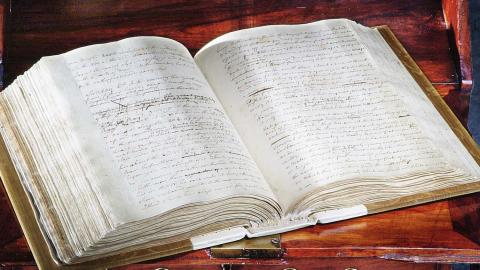 The hardback, handwritten journal of Lieutenant James Cook from 1770, lying open on a table