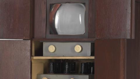 Close up of Sid Oldroyd's homemade TV showing screen and dials inside a wooden cabinet, built in 1956.