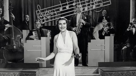 Jazz singer Barbara James singing in front of a jazz band