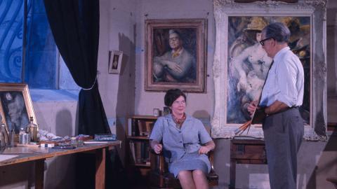 Photograph of Australian artists Margaret Olley and William Dobell. Dobell is painting Olley's portrait in his studio.