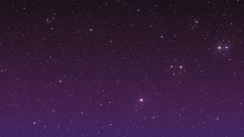 A purple black sky with twinkling stars