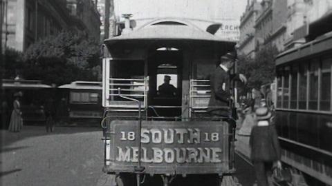 Black and white still of the back of a number 18 South Melbourne tram in the 1910s.